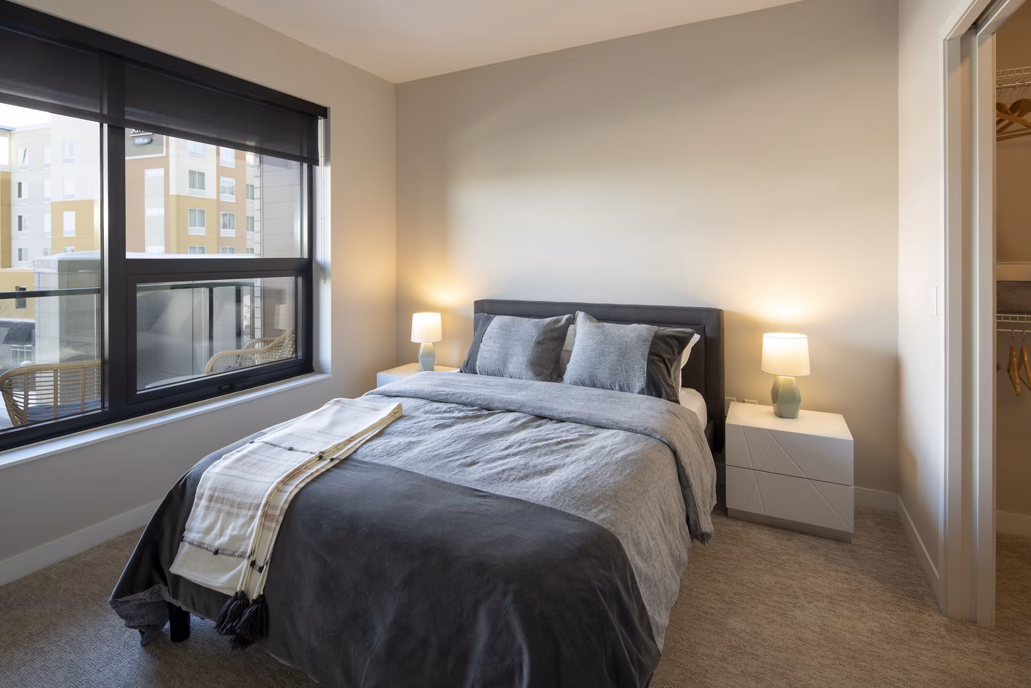 Elegant bedroom with modern furnishings at The Berkman Apartments, luxury living in Rochester