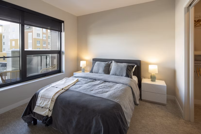 Elegant bedroom with modern furnishings at The Berkman Apartments, luxury living in Rochester