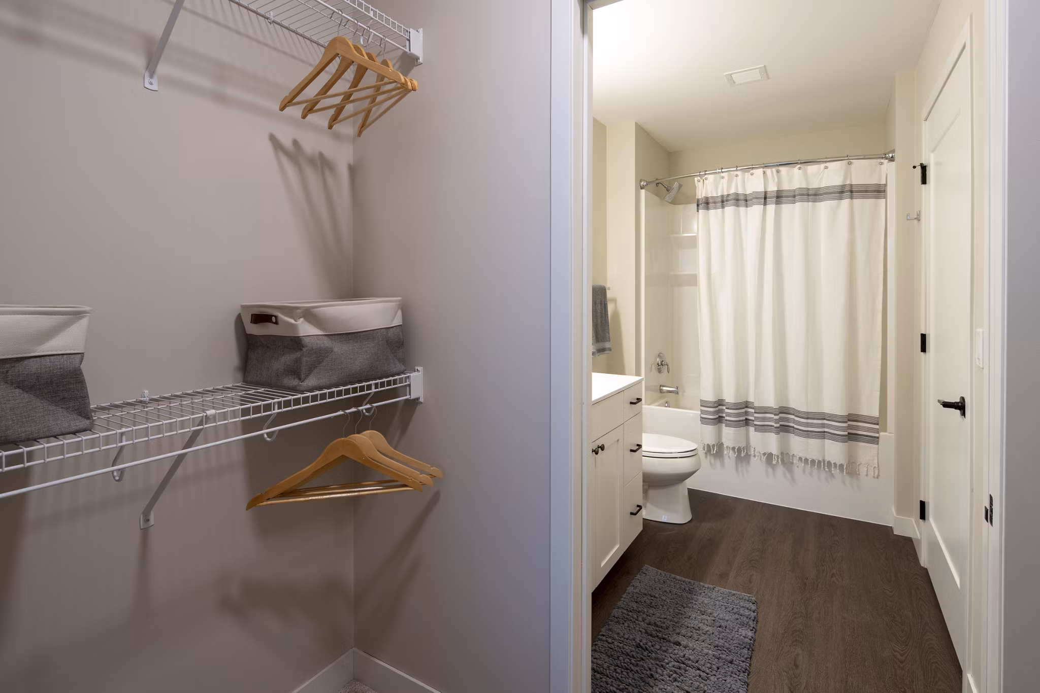 Luxurious bathroom with marble countertops and glass shower in The Berkman Apartments