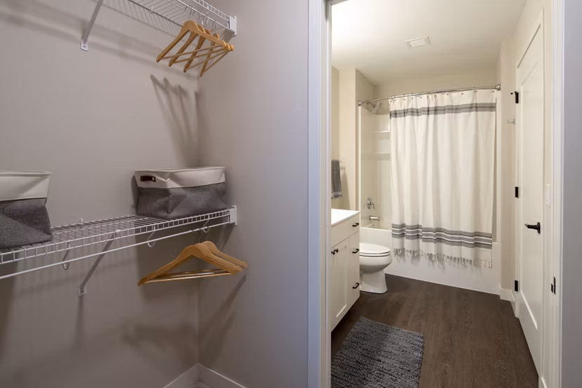 Luxurious bathroom with marble countertops and glass shower in The Berkman Apartments
