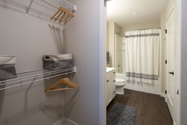 Luxurious bathroom with marble countertops and glass shower in The Berkman Apartments