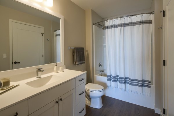 Modern bathroom with sleek fixtures at The Berkman Apartments, featuring luxury design elements and spacious layout, perfect for relaxation