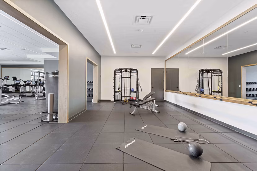 State-of-the-art fitness center with modern equipment at The Berkman Apartments