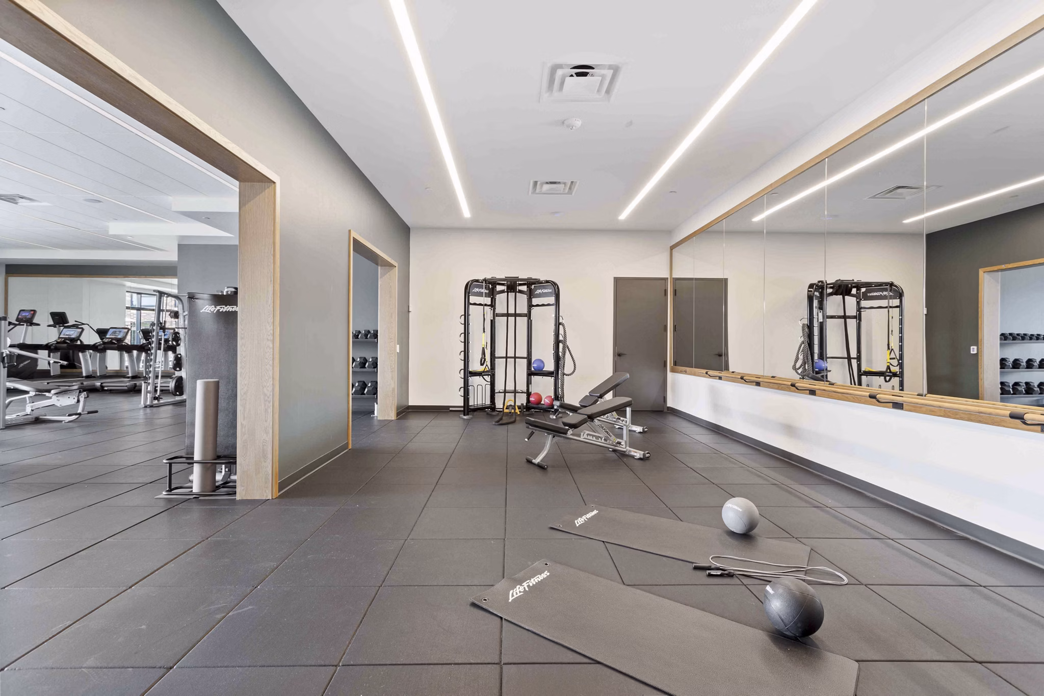 State-of-the-art fitness center with modern equipment at The Berkman Apartments