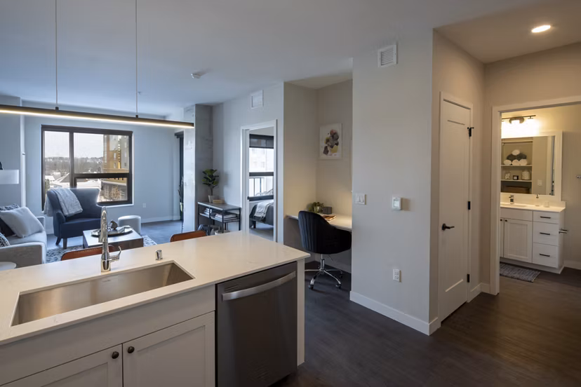 Elegant kitchen with marble countertops and stainless steel appliances in The Berkman Apartments