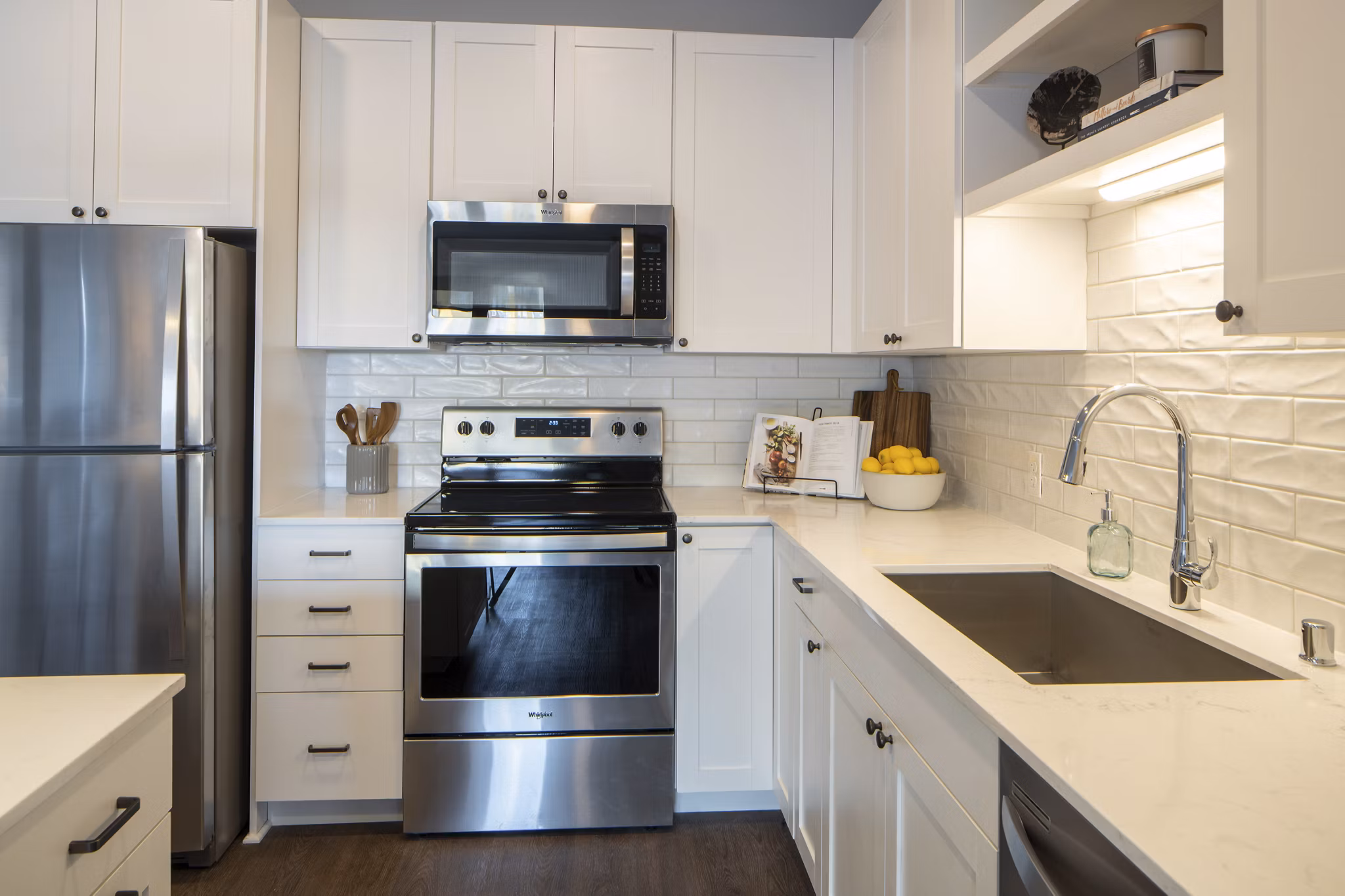 Modern kitchen with stainless steel appliances in The Berkman Apartments