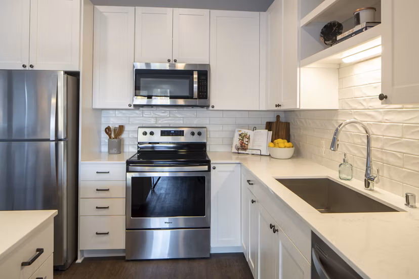 Modern kitchen with stainless steel appliances in The Berkman Apartments