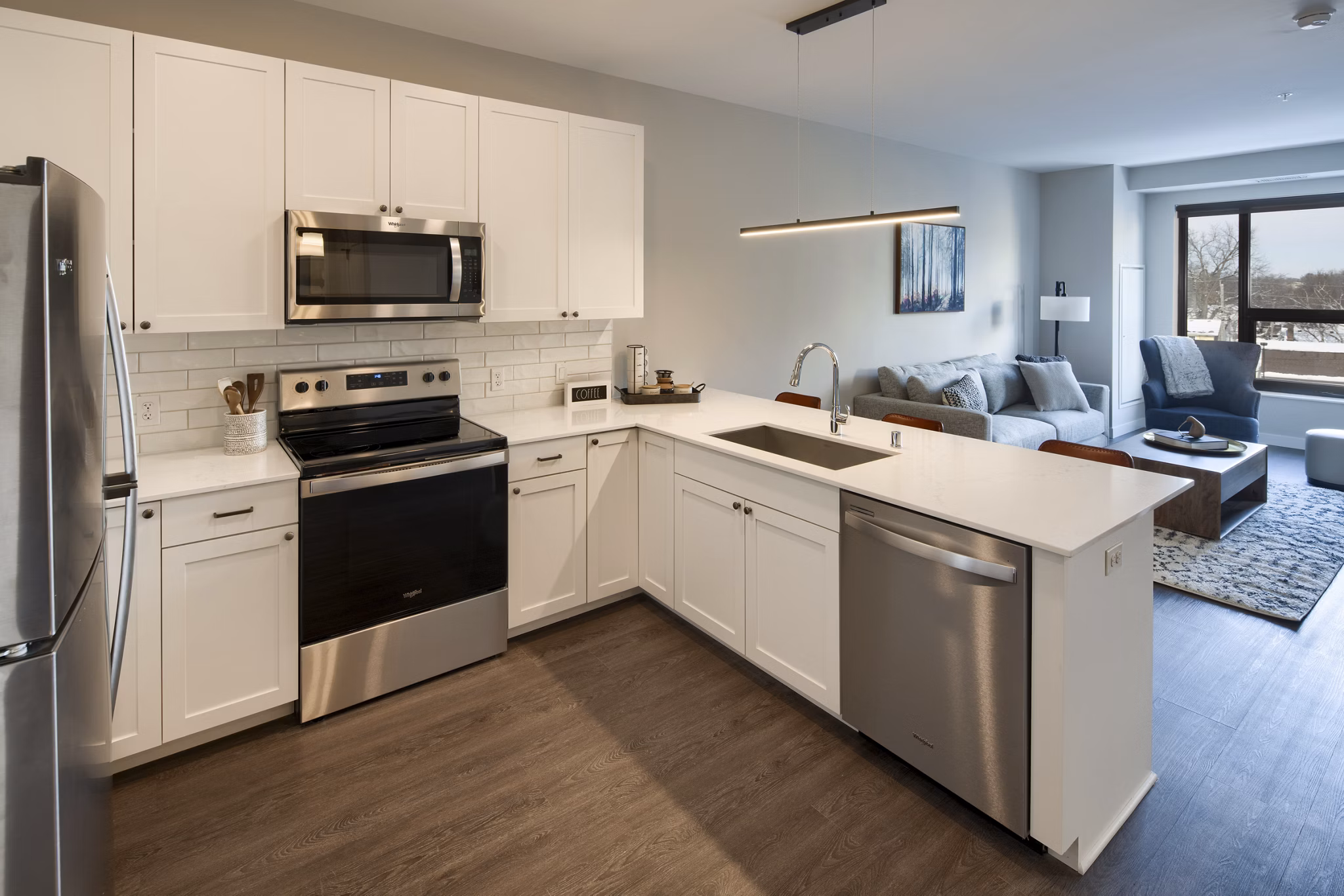 Modern kitchen with sleek cabinetry and stainless steel appliances at The Berkman Apartments