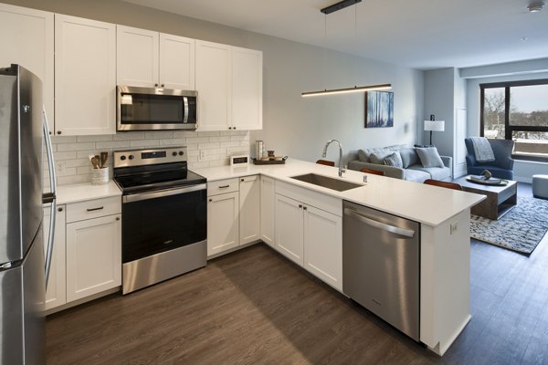 Modern kitchen with sleek cabinetry and stainless steel appliances at The Berkman Apartments