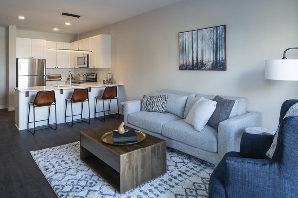 Stylish living room with modern furniture and large windows in The Berkman Apartments