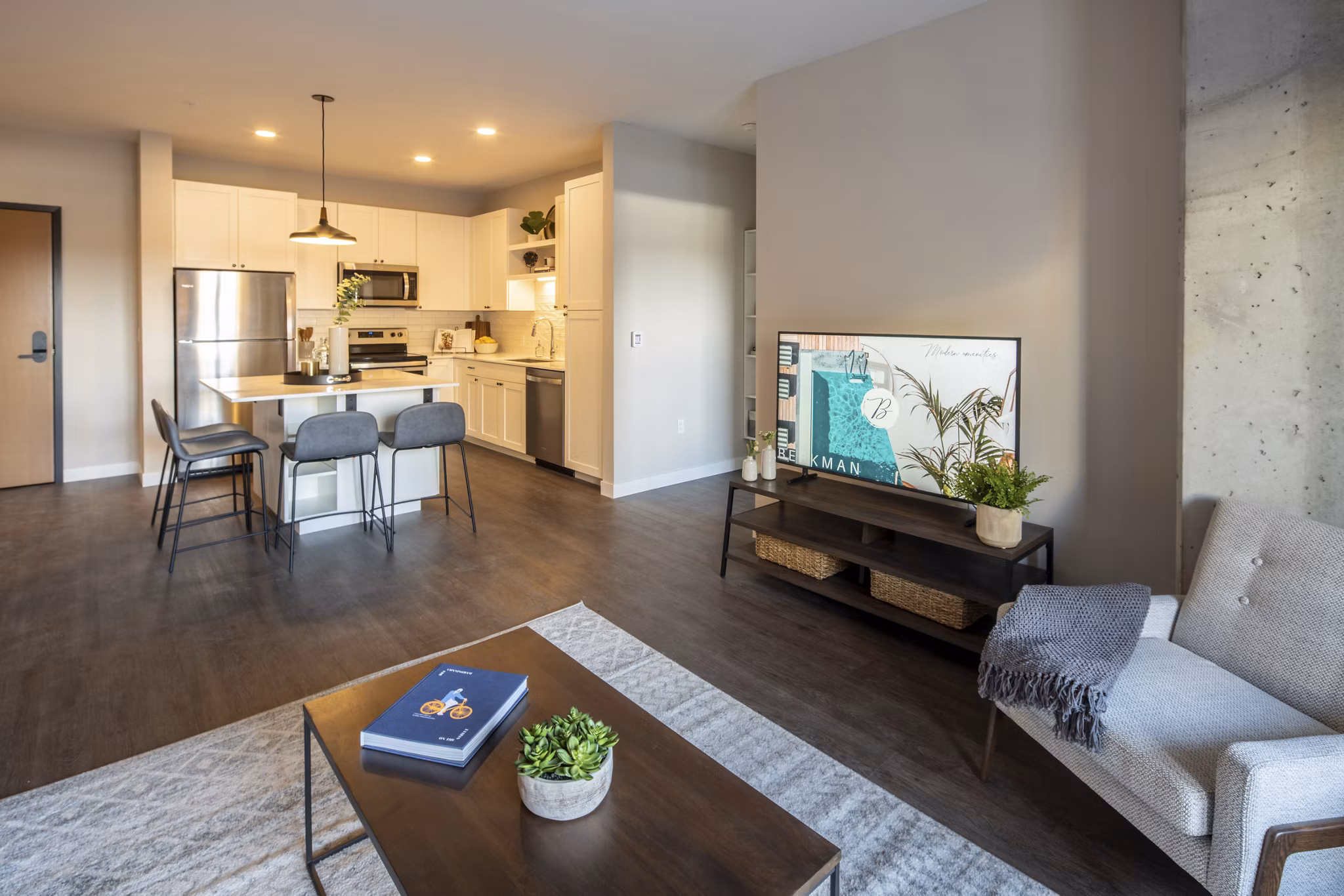 Welcoming living room with contemporary furniture and large windows at The Berkman Apartments