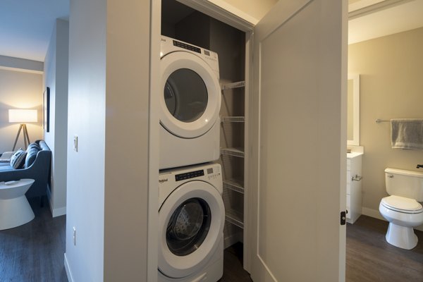 Laundry room with high-efficiency machines at The Berkman Apartments in Rochester