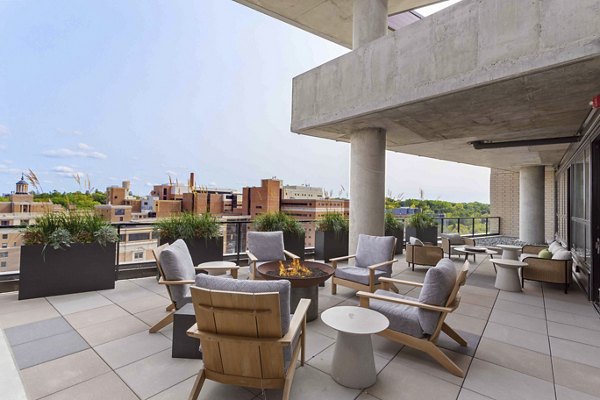 Cozy outdoor fire pit seating area at The Berkman Apartments, perfect for social gatherings and relaxing evenings