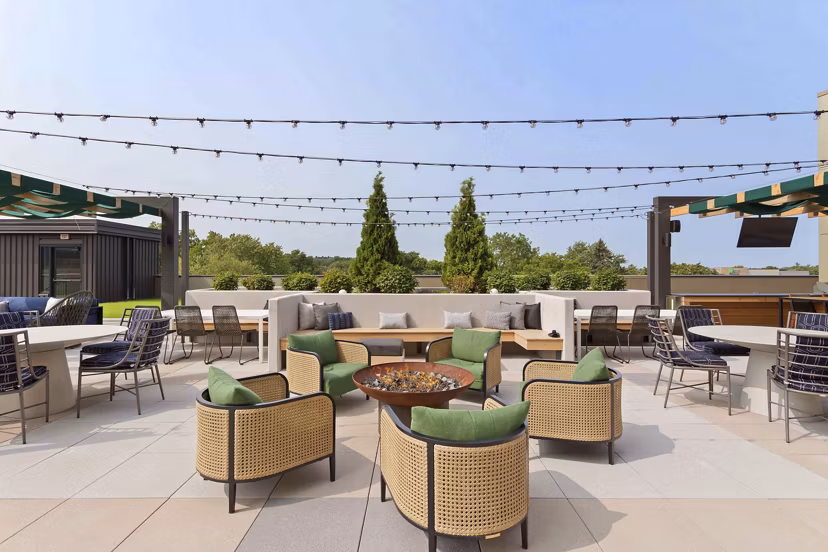 Cozy fire pit area at The Berkman Apartments featuring comfortable seating and modern design