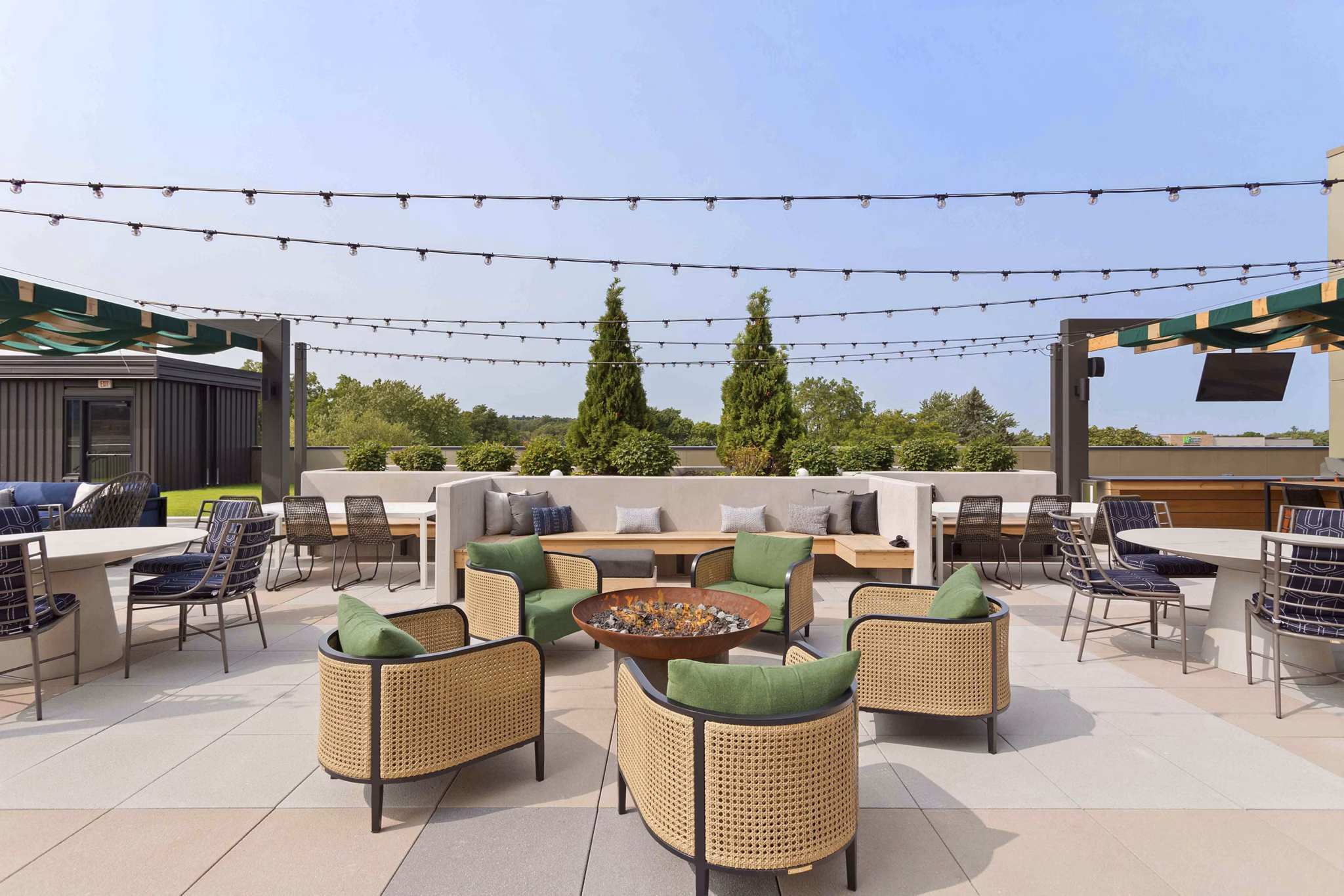 Cozy fire pit area at The Berkman Apartments featuring comfortable seating and modern design