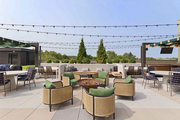 Cozy fire pit area at The Berkman Apartments featuring comfortable seating and modern design