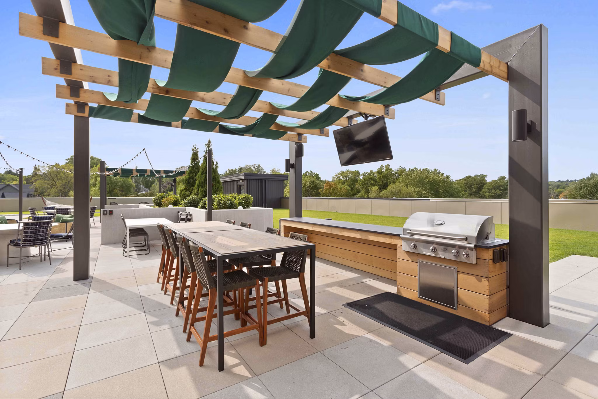Outdoor grill area with modern stainless steel grills at The Berkman Apartments