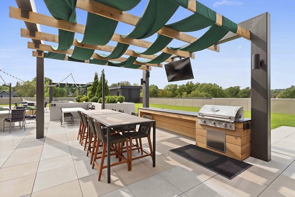 Outdoor grill area with modern stainless steel grills at The Berkman Apartments
