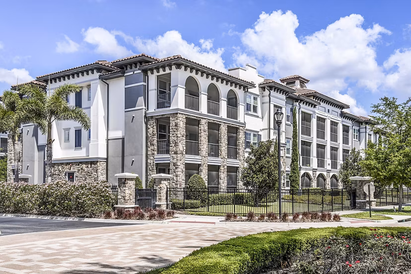 Venetian Isle Apartments: Elegant waterfront building with lush landscaping in Miami