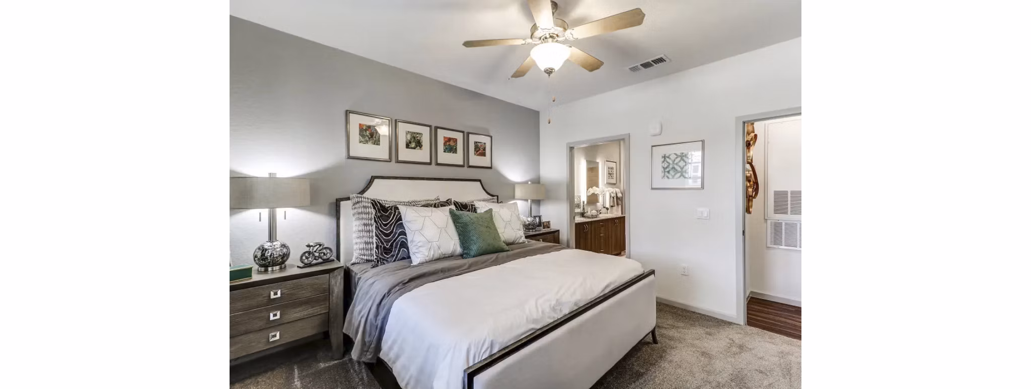 Elegant bedroom with modern decor and ample natural light at Venetian Isle Apartments