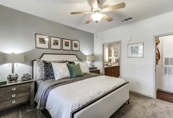 Elegant bedroom with modern decor and ample natural light at Venetian Isle Apartments