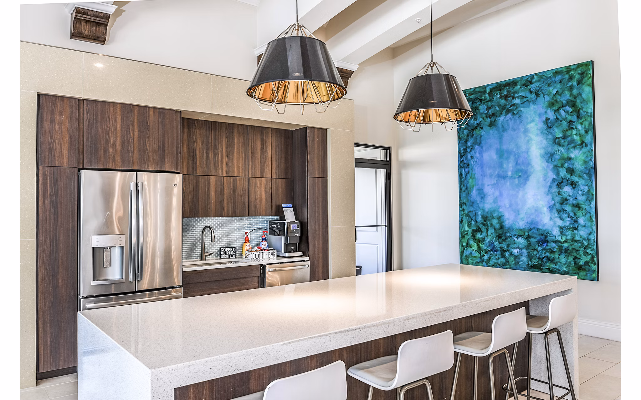 Clubhouse kitchen featuring modern appliances and island seating at Venetian Isle Apartments in luxury community setting