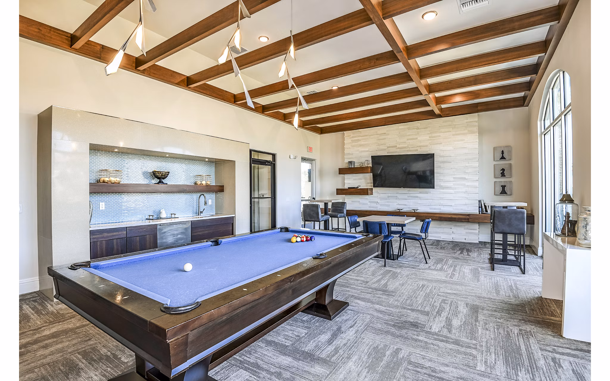Clubhouse game room featuring a pool table and lounge seating at Venetian Isle Apartments