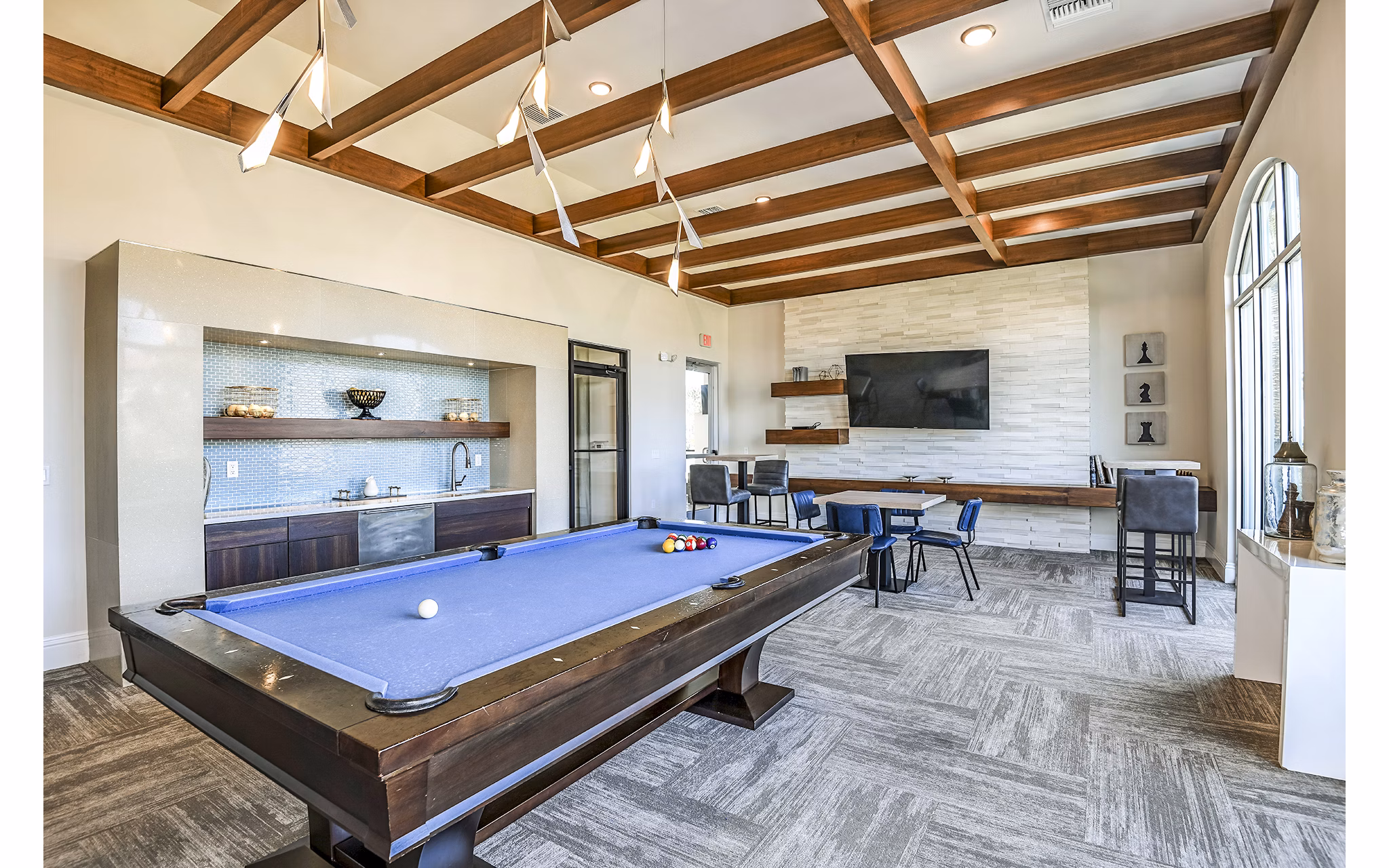 Clubhouse game room featuring a pool table and lounge seating at Venetian Isle Apartments