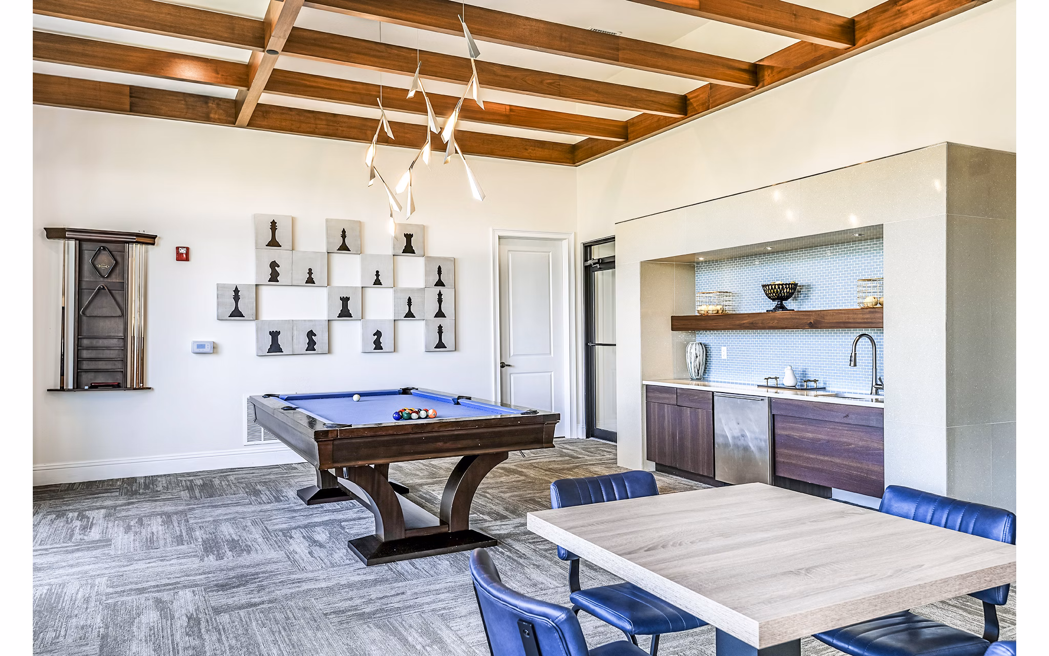 Modern game room with pool table and lounge seating at Venetian Isle Apartments clubhouse
