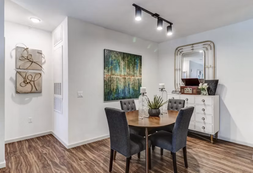 Dining area with elegant lighting and hardwood floors in Venetian Isle Apartments luxury community