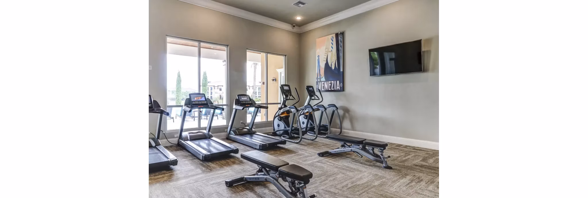 Modern fitness center with state-of-the-art equipment at Venetian Isle Apartments, offering premium workout facilities for residents
