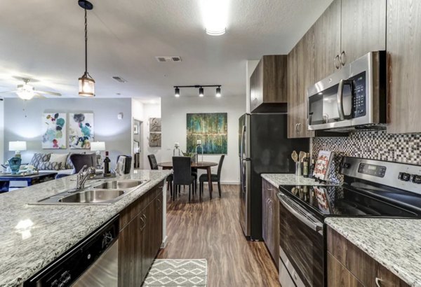 Modern kitchen with stainless steel appliances at Venetian Isle Apartments