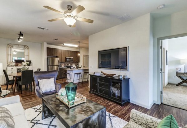 Spacious living room with modern decor and large windows at Venetian Isle Apartments