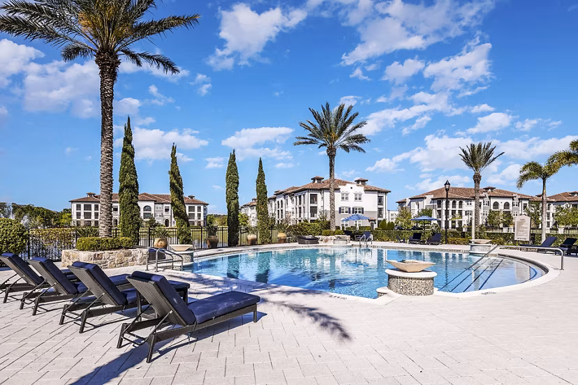 Resort-style pool with palm trees at Venetian Isle Apartments offering luxury living