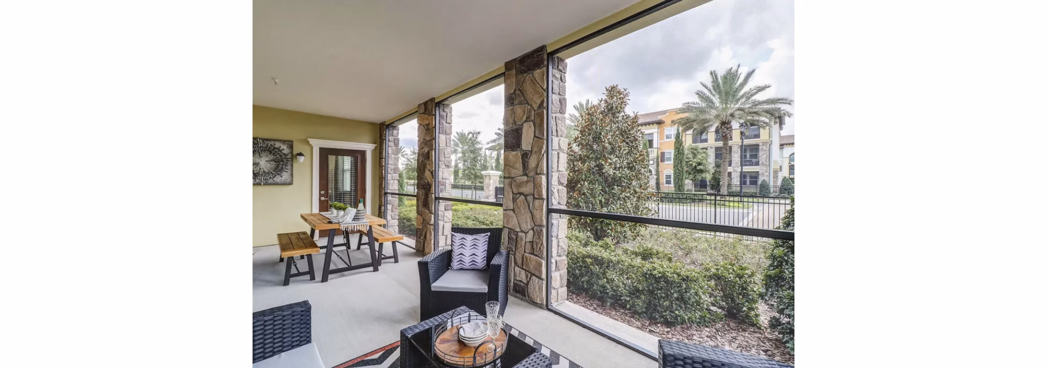 Indoor patio with cozy seating and lush plants at Venetian Isle Apartments, offering a serene retreat