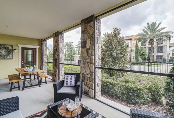Indoor patio with cozy seating and lush plants at Venetian Isle Apartments, offering a serene retreat