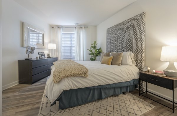Spacious bedroom with modern decor at Arlington 360 Apartments, featuring ample natural light and stylish furnishings