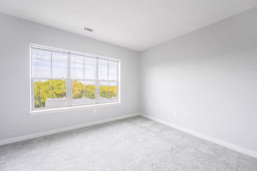 Modern bedroom with chic decor at Arlington 360 Apartments, featuring cozy bedding and ample natural light Perfect for a stylish living experience