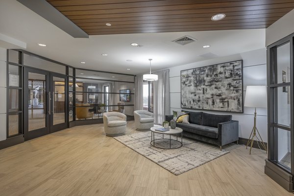 Modern clubhouse with cozy seating and entertainment area at Arlington 360 Apartments, a luxury Greystar community in Arlington, MA