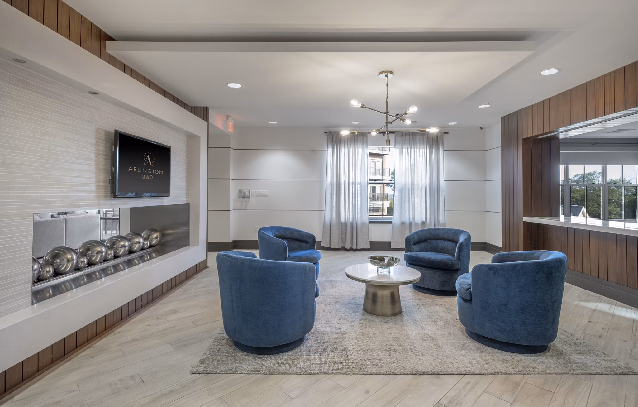 Modern clubhouse with expansive seating at Arlington 360 Apartments featuring luxury amenities in Arlington
