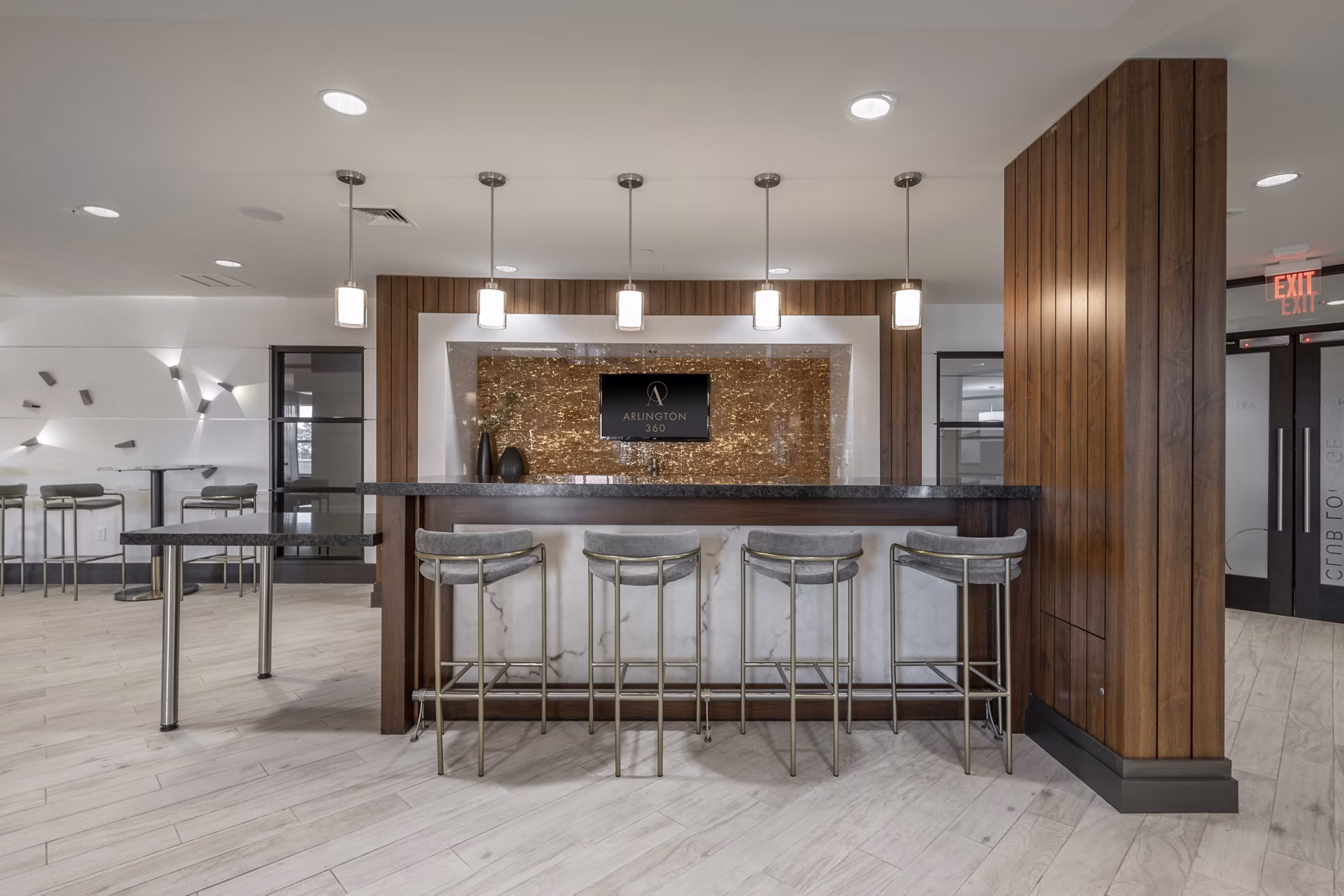 Modern clubhouse with stylish seating and gaming areas at Arlington 360 Apartments in Arlington