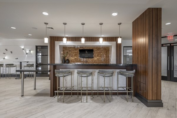 Modern clubhouse with stylish seating and gaming areas at Arlington 360 Apartments in Arlington