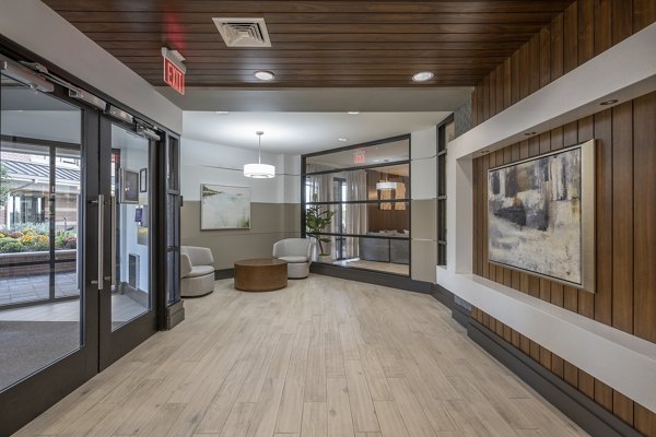 Elegant clubhouse featuring lounge seating and games at Arlington 360 Apartments, offering luxury living in a scenic location