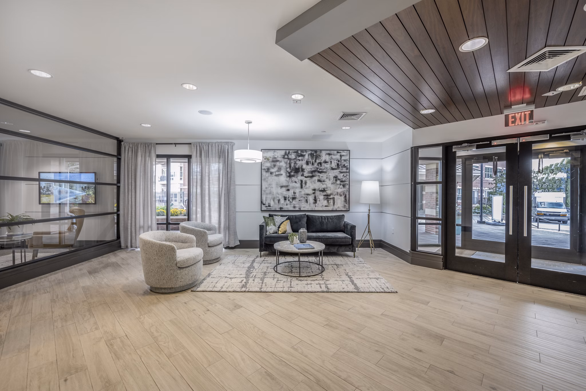 Clubhouse with modern interior design at Arlington 360 Apartments featuring a spacious seating area and community spaces
