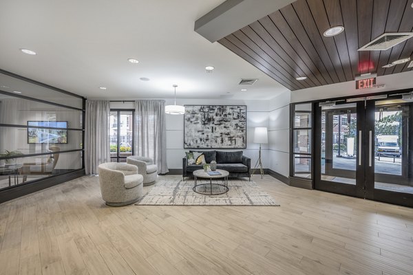 Clubhouse with modern interior design at Arlington 360 Apartments featuring a spacious seating area and community spaces