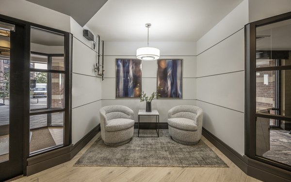Clubhouse with modern interiors and lounge seating at Arlington 360 Apartments