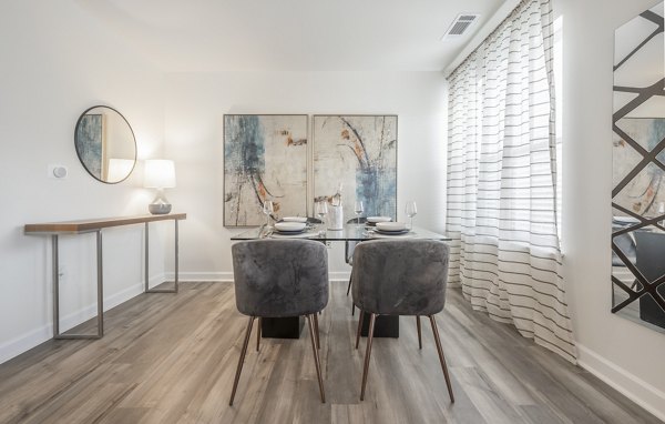 Dine in style at Arlington 360 Apartments: Sleek dining area with modern decor and ample natural light Perfect for entertaining