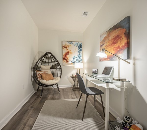 Home office space with modern desk and ergonomic chair in Arlington 360 Apartments, perfect for remote work and productivity