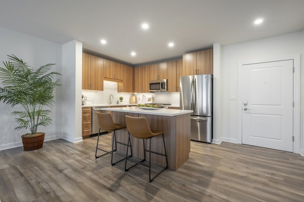 Modern kitchen with stainless steel appliances in Arlington 360 Apartments