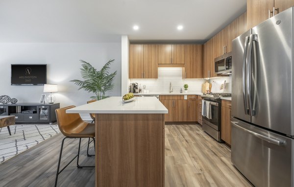 Arlington 360 Apartments: Modern kitchen with stainless steel appliances and island counter